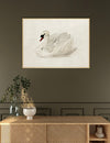 Framed artwork of a swan on a wall above a wooden console table.
