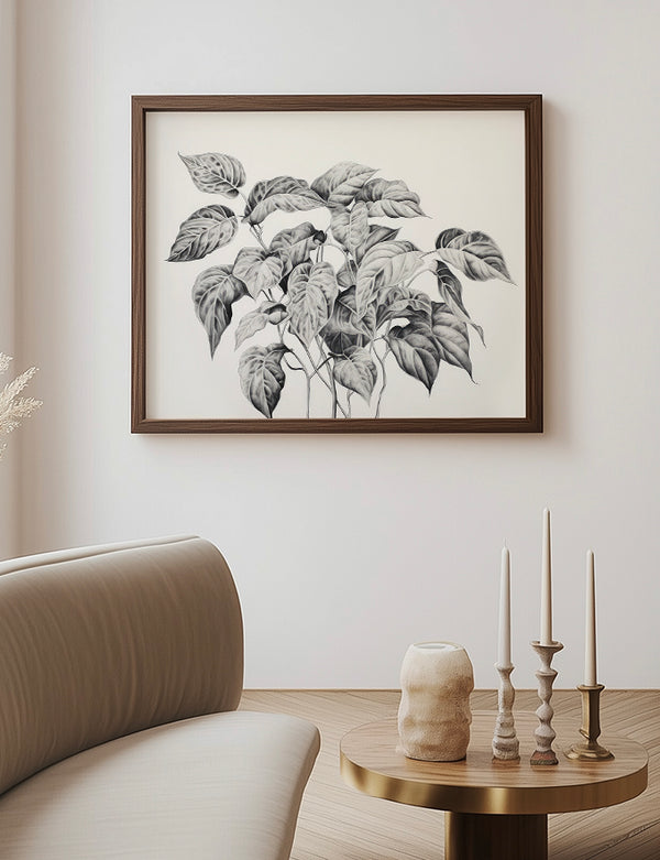Framed botanical artwork on a wall above a sofa and side table with decorative items.