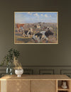 Framed painting of cows in a field on a wall above a wooden console table.