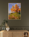 Framed painting of a landscape with trees and a cabin on a wall above a wooden console table.