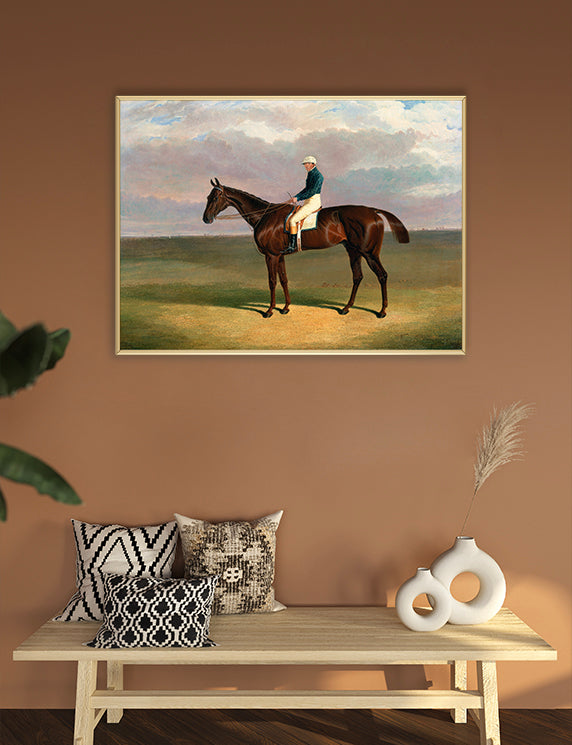Framed painting of a horse and jockey on a wall above a wooden bench with decorative pillows and vases.
