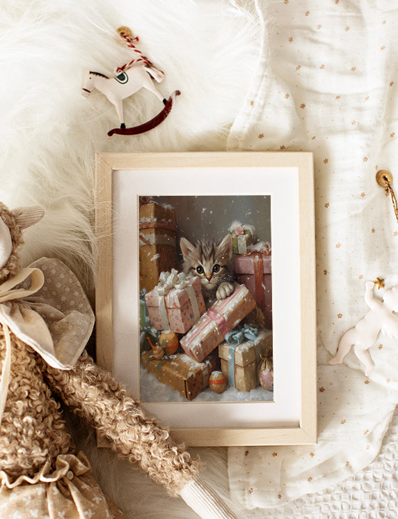 Framed picture of a kitten among Christmas presents on a soft surface with toys.