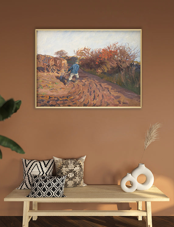 Framed painting of a landscape with a person walking on a path, displayed above a wooden bench with decorative pillows and vases.