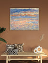 Framed abstract painting on a wall above a wooden bench with decorative pillows and vases.