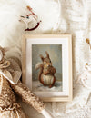 Framed artwork of a squirrel holding a pine cone on a soft, textured background.