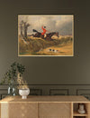 Framed painting of a hunter on horseback with dogs in a field, above a wooden console table.
