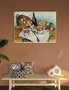 Framed painting of still life on a wall above a wooden bench with decorative pillows and vases.