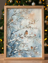 Framed artwork of birds on branches with snow against a blurred Christmas tree background