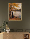 Framed painting of a person by a lake on a wall above a wooden console table.