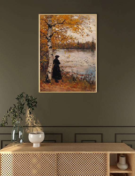 Framed painting of a person by a lake on a wall above a wooden console table.