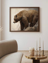 Framed artwork of a bear on a wall above a sofa and side table.