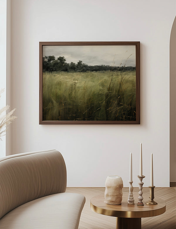 Framed landscape print on a wall above a table with decorative items in a room.