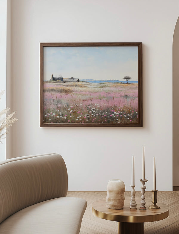 Framed landscape painting on a wall above a table with decorative items in a living room.