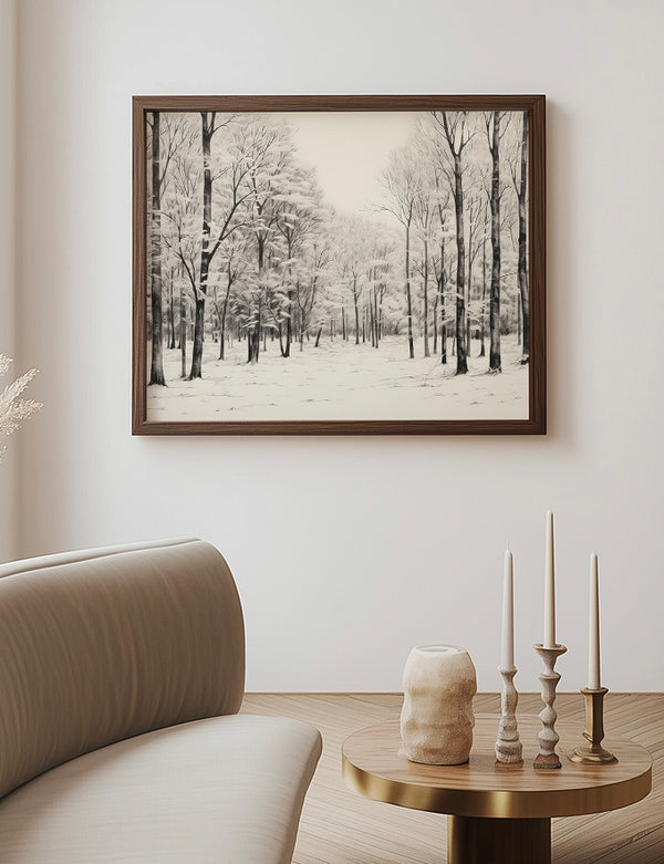 Framed winter landscape print on a wall above a sofa and side table with candles.
