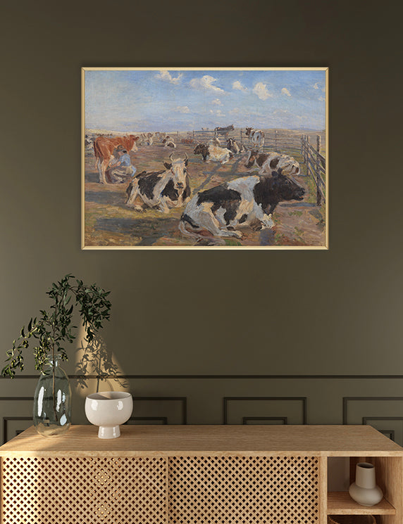 Framed painting of cows in a field on a wall above a wooden console table.