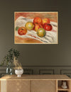 Framed painting of apples on a dark wall above a wooden console table.