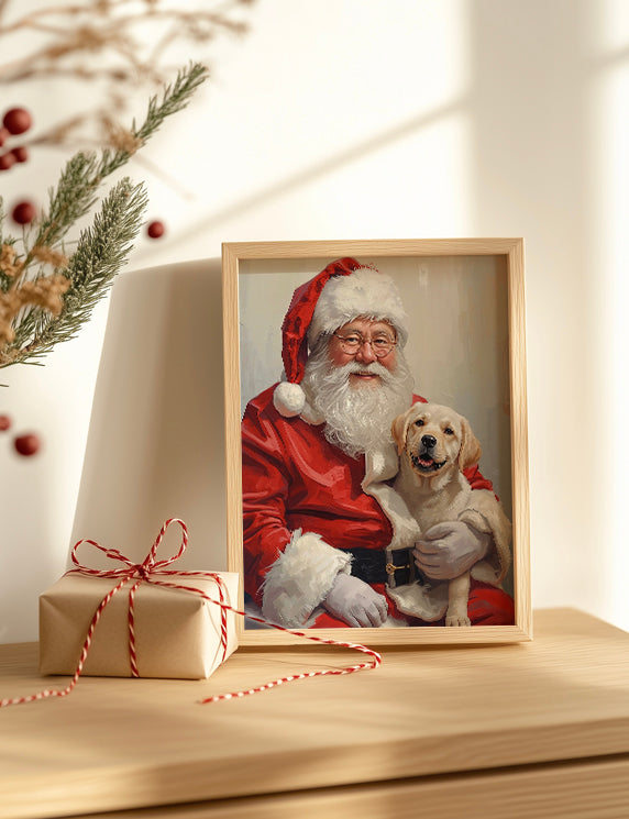 Framed picture of Santa Claus with a dog next to a wrapped gift on a wooden surface.