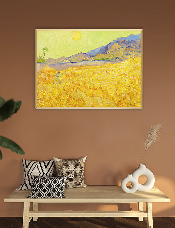 Framed painting of a sunflower field on a wall above a wooden bench with decorative pillows and vases.