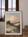 Framed landscape painting on a wall with a window in the background