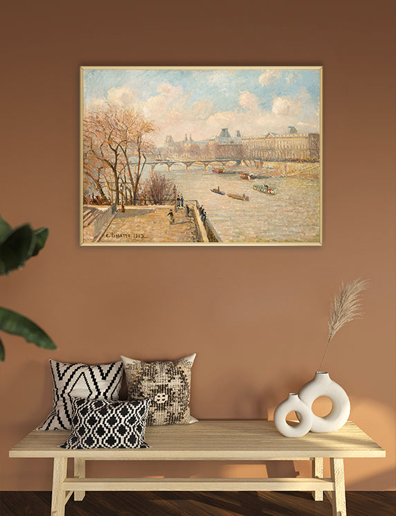 Framed painting on a wall above a wooden bench with decorative pillows and vases.