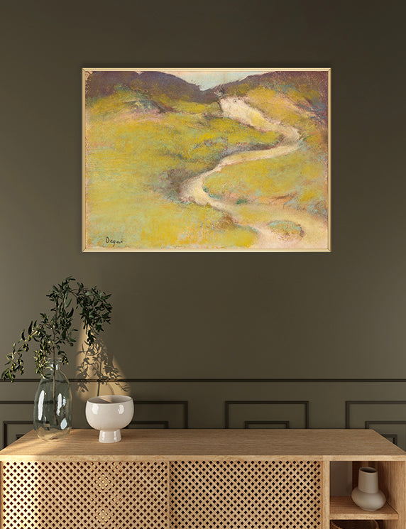 Artistic depiction of a winding path through a landscape on a wall above a wooden console table.